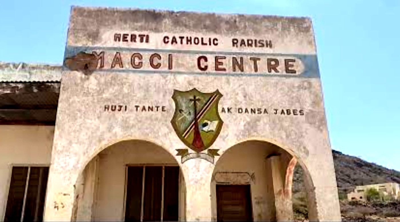 The Macci Centre social hall in Merti, with the mission's motto painted across its front